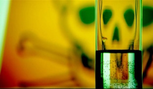tubo di laboratorio con foto di fondo con un teschio giallo e verde
